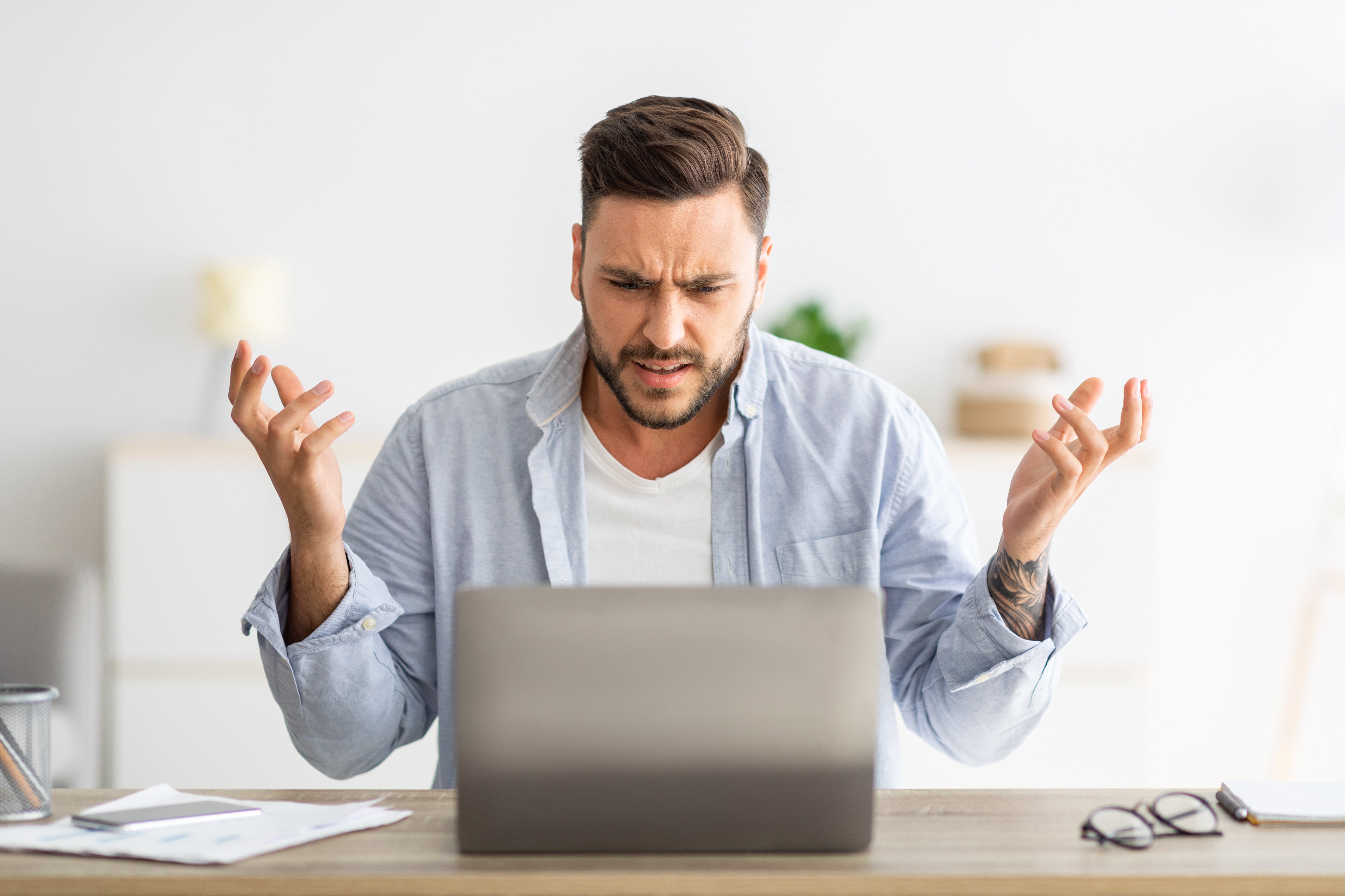 angry-millennial-man-looking-at-laptop-screen-and-2021-12-09-08-14-51-utc