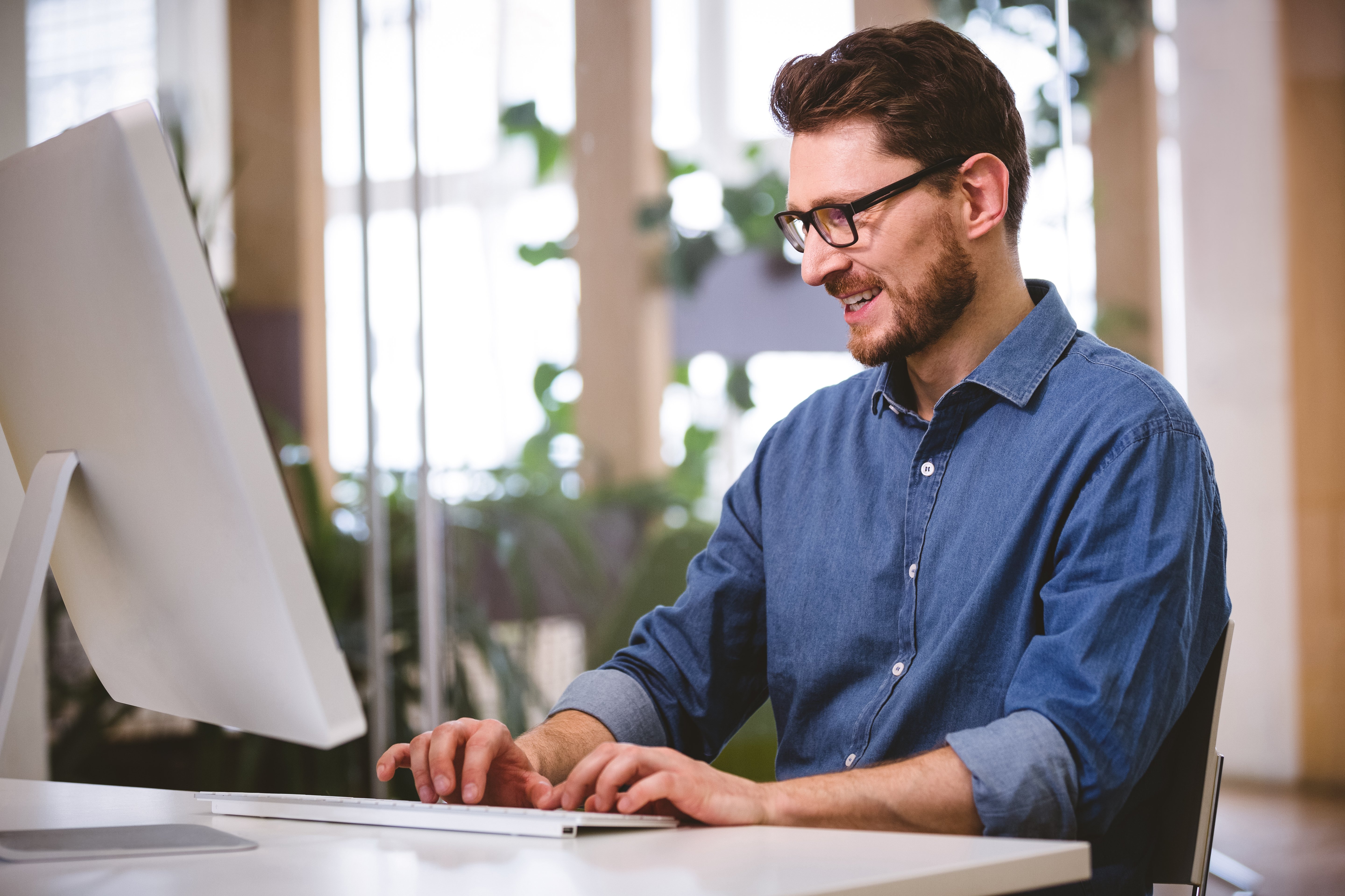 happy-businessman-working-on-computer-at-creative-2021-08-28-17-23-30-utc