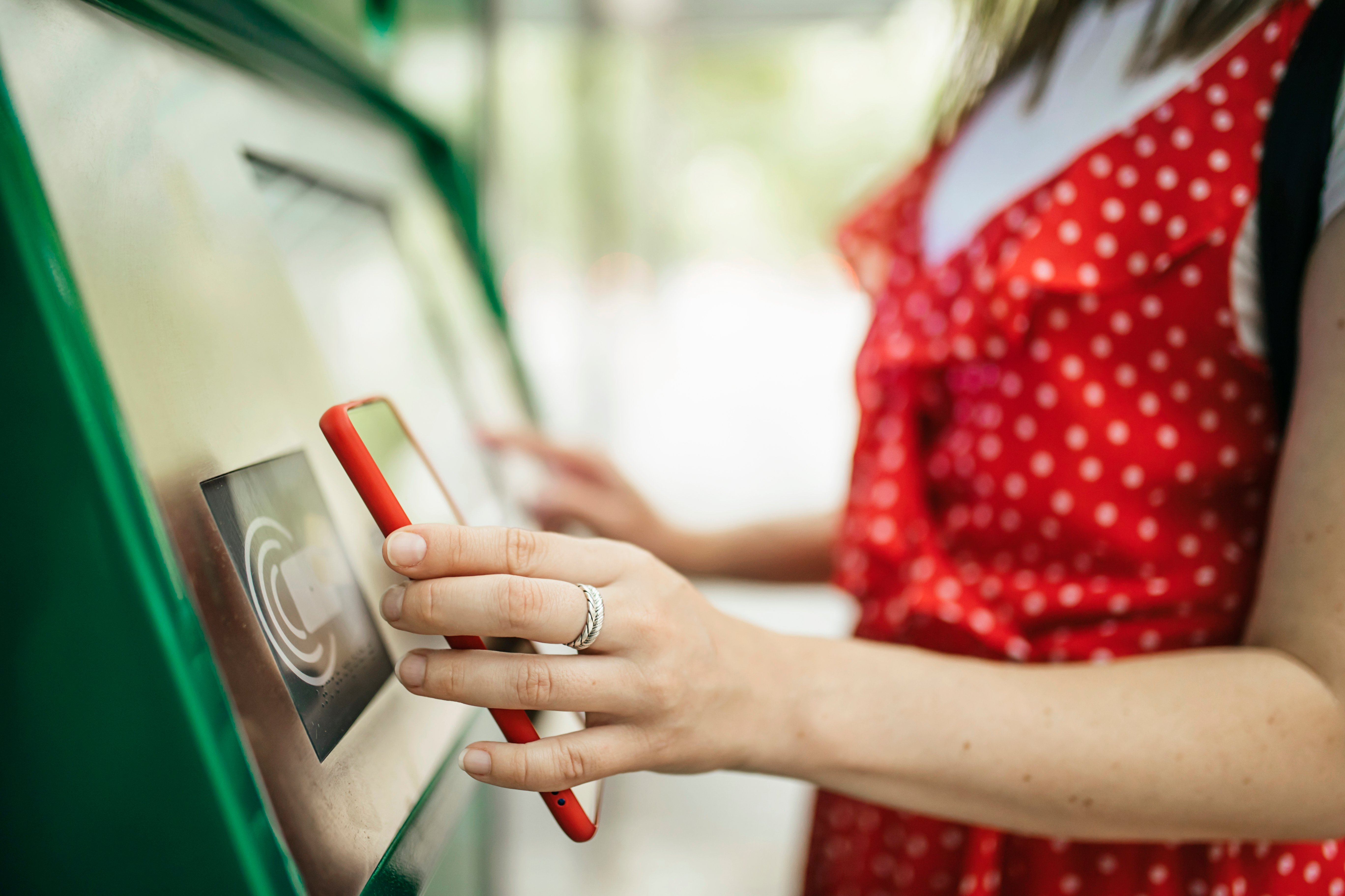 young-woman-paying-with-mobile-phone-app-for-the-p-2022-02-04-19-46-31-utc